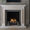 Chesneys Alderney fireplace with the Morris fire basket for dogs and Spherical Steel fire dogs
